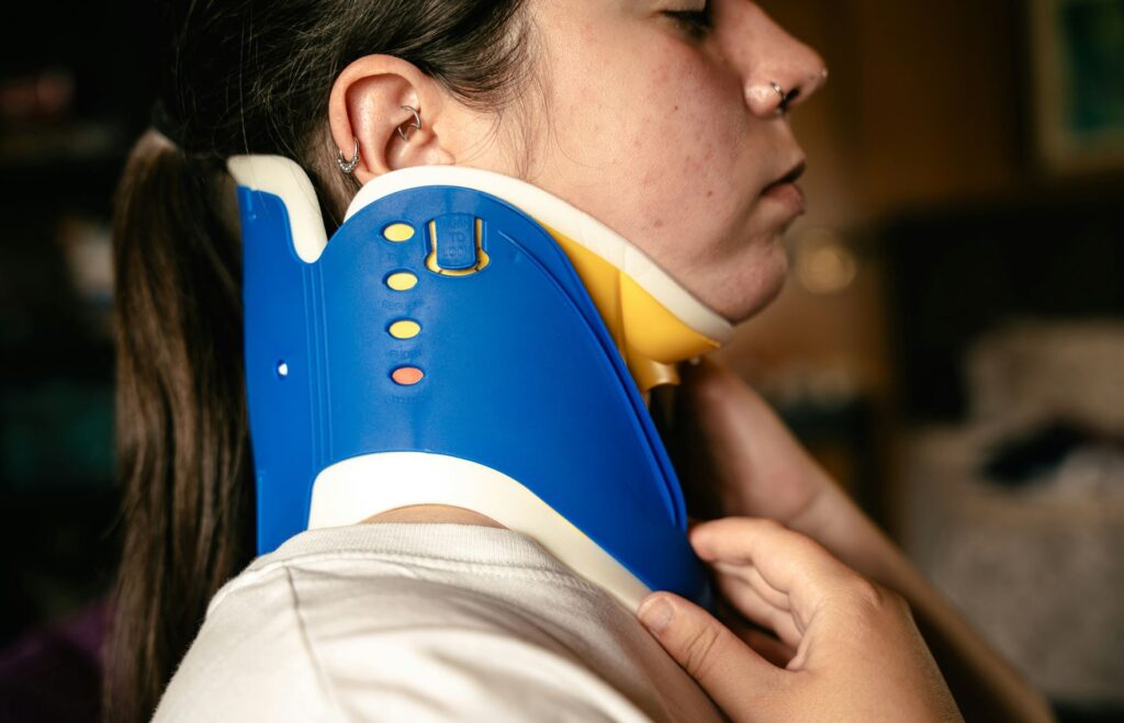 neck brace spine injury after accident woman with piercings from san antonio