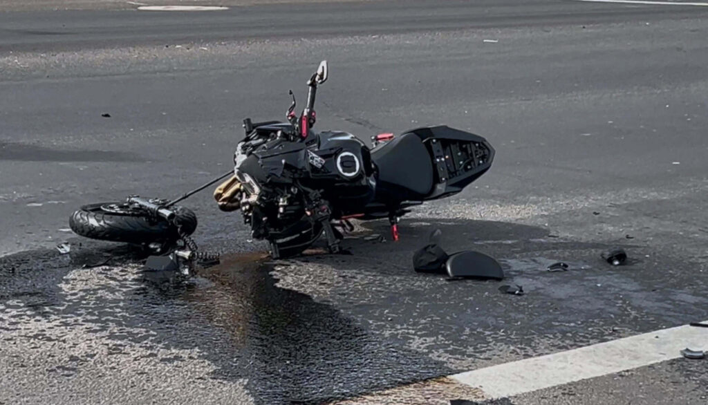 black motorcycle crashed on road san antonio leaking fluid serious wreck